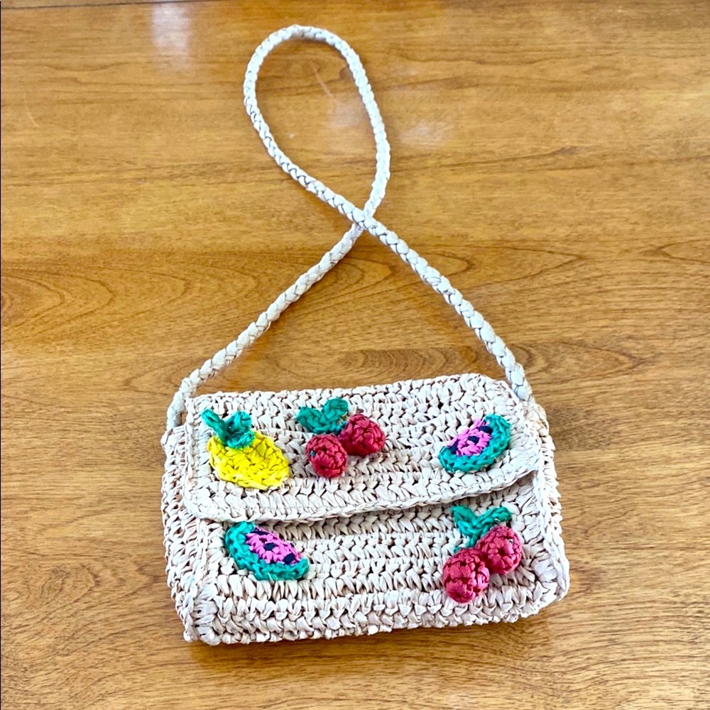 Zara crossbody straw bag with fruit embellishments.